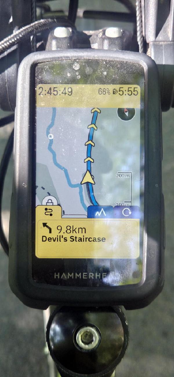 Hammerhead cycling computer mounted on handlebars displaying 9.8km to the Devil&rsquo;s Staircase