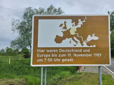 A brown road sign marking the old border between East and West Germany in Schöningen, Lower Saxony. 