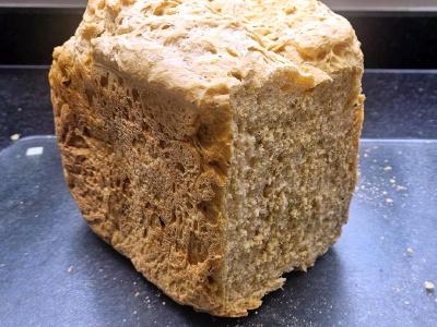 Tomato and cheese loaf with the cut end showing an open, slightly uneven crumb.