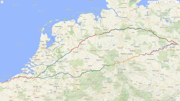 A wide map view of northern France, Belgium, the Netherlands, and northern Germany showing a multi-day cycling route made up of several coloured GPS tracks. The route begins near Dunkirk on the French coast, passes through or near Antwerp, Eindhoven, Arnhem and Apeldoorn, then continues east across Germany through cities such as Osnabrück, Bremen, Magdeburg and towards Berlin. Each day or segment is shown in a different colour (red, blue, green, orange, purple, black) overlaid on a detailed road and place-name basemap